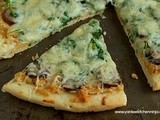 Smoked sausage pizza with arugula and caramelized onion and goat cheese sauce