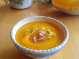 Pumpkin and red onion soup with thyme and rosemary flowers