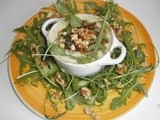 Eggs in a mini casserole dish with a roquefort cream, salad rocket and walnuts