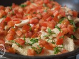 Chicken steaks with tomato and mint leaves
