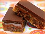 Chocolate chip cookie bars stuffed with a caramel kiss ganache and topped with a smooth chocolate ganache