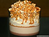 Chocolate ganache & salted caramel panna cotta trifle topped with whipped cream & caramel popcorn