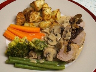 Pork tenderloin stuffed with sherry soaked prunes and chestnuts, in a mushroom cream sauce