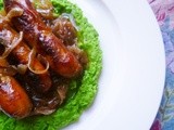 Summery sausages and caramelised onions with crushed buttered peas