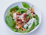 Bean and Quinoa salad complimented with spinach, topped with a lemon & garlic yogurt dressing
