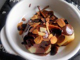 Steamed pears served with chocolate sauce and roasted almond flakes