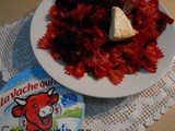 Red bowtie pasta with beetroot and triangular shape cheese