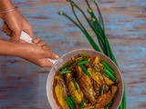 Piajkoli ar Aloo diye Tangra Macher Jhol (Bengali Light fish curry prepared with Tyangra Maach, Onion Stalks and Potato)