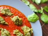 Curry of steamed spinach and courgette dumplings in a spiced, roasted red pepper base