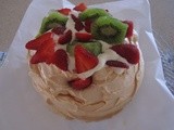 Pavlova filled with cream and fresh fruits