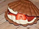 Chocolate shell filled with strawberries & whipped cream