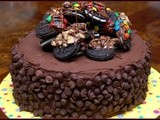 Triple layer cake- 2 chocolate layers & 1 cheesecake layer filled with caramel and topped with chocolate dipped oreos