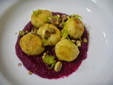 Pumpkin ricotta gnocchi on beetroot sauce with pistachios and orange