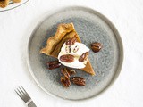 Sweet potato pie with whipped cream and maple pecans