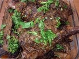 Roasted leg of mutton on a bed of sliced potatoes